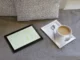 A cozy scene with a tablet displaying text next to a cup of coffee on a soft surface, suggesting a relaxed reading experience about health and wellness products.