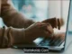 Close-up of a person's hands typing on a laptop keyboard, with "Statekaidz.com" watermarked at the bottom of the image.