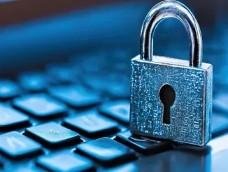 A silver metallic padlock resting on a blue-toned computer keyboard, symbolizing data security and digital protection.